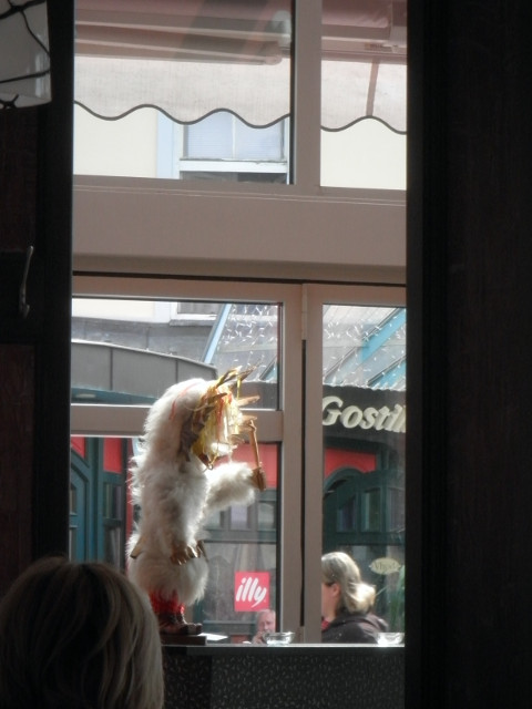 scale model kurent fuzz-looking figurine in cafe window