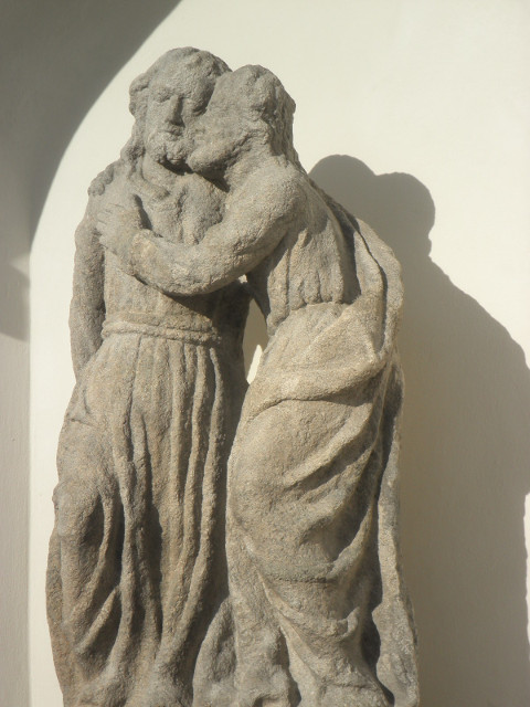 Two Old Guys stone statue, mounted high