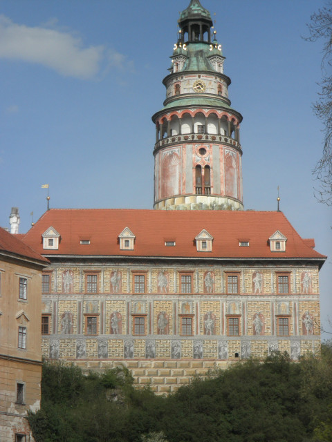Exterior Decoratioon round tower behind castle building, both intricately painted
