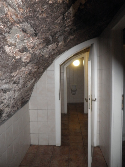 Restroom in the Dungeon doors in stone-roofed passage