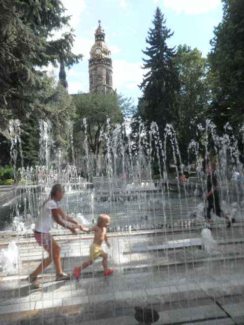 Košice - Musical Fountain Young girl and toddler running through fountain
