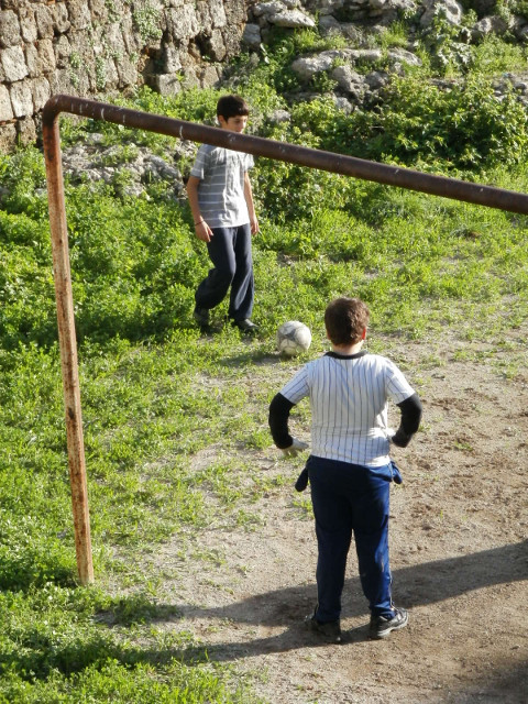 Football in the moat couple of kids kicking a ball around